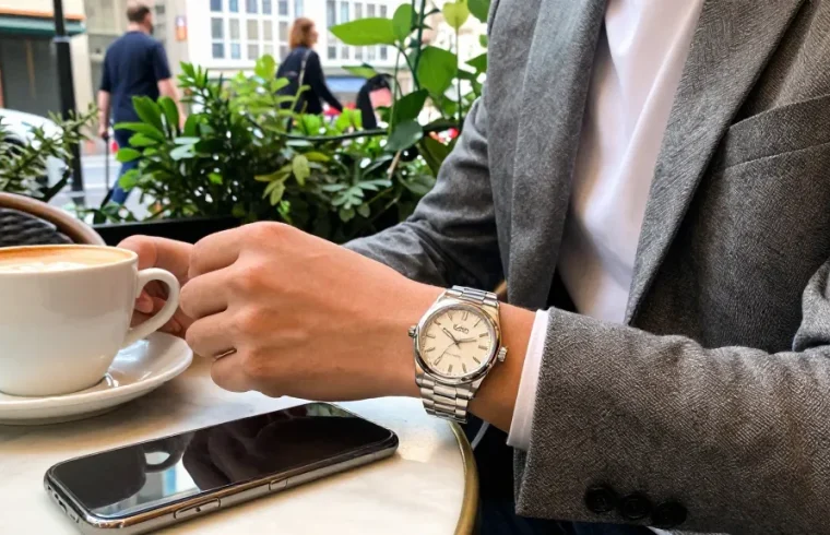 Elegant individual showcasing a premium clone watch in a chic café setting, emphasizing luxury and lifestyle.